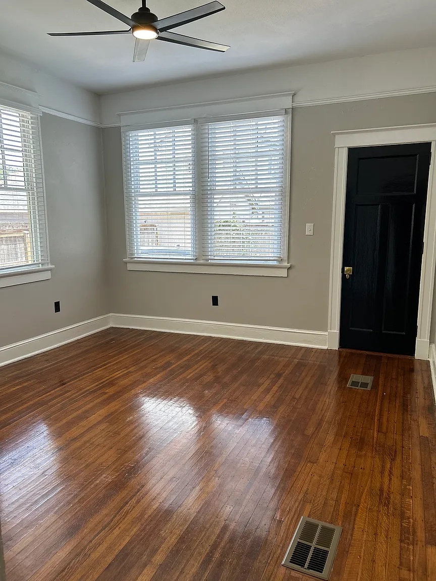 Bedroom with large windows, ceiling fan and hardwood floors