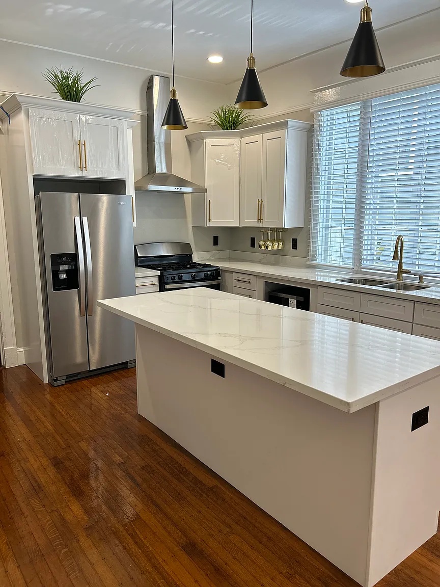 Kitchen island with stainless steel appliances and gas range