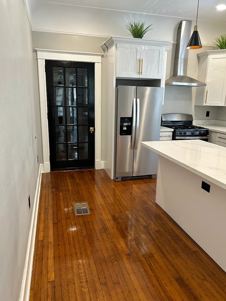 Kitchen entry with black glass door and refrigerator